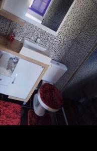 a bathroom with a white sink and a stool at Pousada Oliveira in Ametista do Sul +6 photos