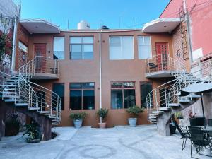 an apartment building with stairs and a table and chairs at Casa Franlus Depa4 in San Cristóbal de Las Casas