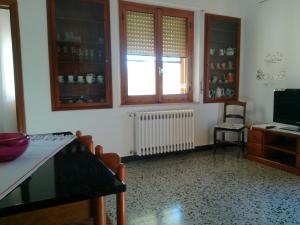 a living room with a table and a window at Cappuccini apartments superior in Oristano