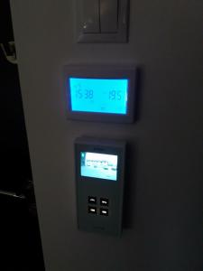 an alarm clock on a wall with a clock on it at Sophia Studio in Iaşi