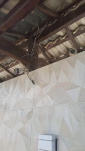 a ceiling with a camera on a white wall at Apartamento Sol e Lua in Lauro de Freitas