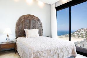 a bedroom with a large bed and a large window at Villa Calista by Important Group Travel in Yalıkavak +65 photos