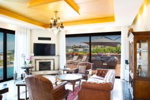 a living room filled with furniture and a fireplace at Villa Calista by Important Group Travel in Yalıkavak