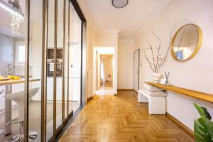 a bathroom with a wooden floor and a mirror at Cozy Apartment - Best Location in Athens in Athens +52 photos