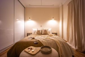 a bedroom with a bed with a tray of food on it at Cozy Apartment - Best Location in Athens in Athens