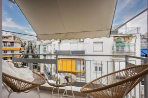 a balcony with chairs and a view of a building at Cozy Apartment - Best Location in Athens in Athens