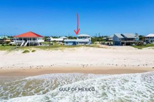 a view of a beach with houses in the background at Beachfront Coastal Cottage St George Island in St. George Island