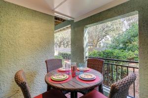 a wooden table with plates of food on a balcony at Clipper Court 816 in Hilton Head Island