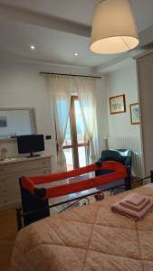 a bedroom with a bed and a desk and a television at La casa di Panfilo in Sulmona