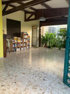 a large room with a large tile floor and wooden ceilings at La Perle Bleue, ,Condo 1 chambre bord de mer et piscine ,Trois ilets in Les Trois-Îlets