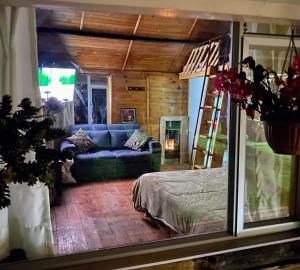 a room with a bed and a couch and a ladder at El camino del viento Sopó in Estación El Salto