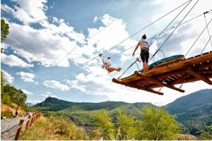a man and a dog on a zip line in the mountains at Vivienda turística Las 3 A in El Ojuelo