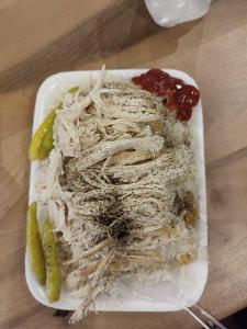 a plate of food with chicken and pickles on a table at SHER e PUNJAB HOSTEL in Baku