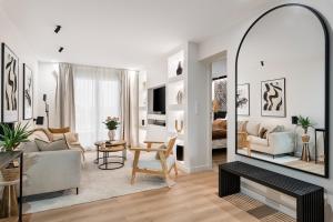 a living room with a mirror and a couch at La consulte - exceptional apartment in Saint-Étienne