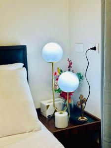 a lamp on a table next to a bed at Royal Oceancrest Panglao I in Dauis +7 photos