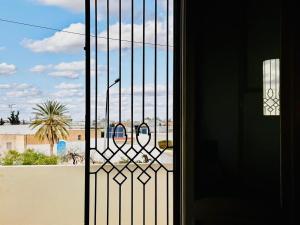 a door with a window with a view of a desert at Villa Olivier in Sakiet ez Zit +8 photos
