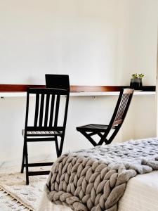 a bedroom with two chairs and a table and a bed at Villa Olivier in Sakiet ez Zit