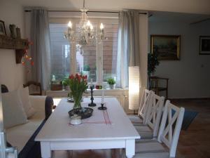 a living room with a white table with flowers on it at Ferienhaus Münzenberg 53 in Quedlinburg +47 photos