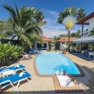a swimming pool with blue chairs and a house at chenxiao in Moody