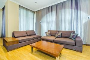a living room with a couch and a coffee table at Apartment on Leylek in Baku +3 photos