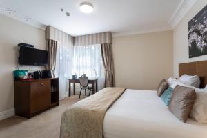 Postel nebo postele na pokoji v ubytování Tuakau Hotel