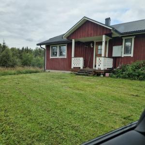 a red house with a lawn in front of it at Ånnstugan in Duved +22 photos