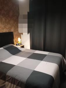 una camera con un letto bianco e nero e una lampada di Delpaulo a Olivet