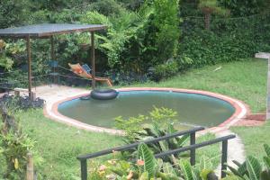 a small swimming pool in a yard with a gazebo at Finca la soñada in Papagalleros