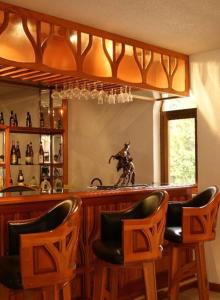 een bar met 2 stoelen en een bar met een spiegel bij Quintaesencia Hotel Boutique in Huasca de Ocampo