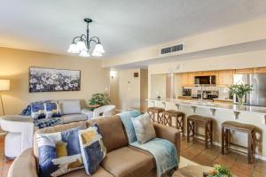 a living room with a couch and a kitchen at Private Pool & Fire Pit! Walkable Tucson Retreat in Tucson