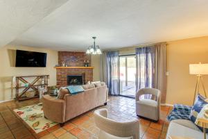 a living room with a couch and a fireplace at Private Pool & Fire Pit! Walkable Tucson Retreat in Tucson