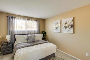 a bedroom with a bed and two paintings on the wall at Private Pool & Fire Pit! Walkable Tucson Retreat in Tucson +33 photos