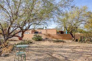 a table and chairs in a yard with trees at Private Pool & Fire Pit! Walkable Tucson Retreat in Tucson