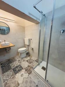 a bathroom with a shower and a toilet and a sink at La Luna in Castellammare del Golfo