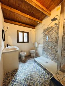 a bathroom with a tub and a toilet and a sink at La Luna in Castellammare del Golfo