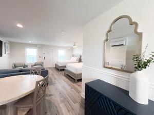 a living room with a couch and a dining room at 2003 Queen Suite, 2nd Floor Cove in Surf City +22 photos