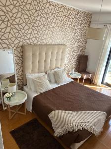 En eller flere senge i et værelse på Vivenda Rosa Lagos