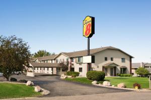 a sign for a mcdonalds restaurant in front of a building at Super 8 by Wyndham Alexandria MN in Alexandria