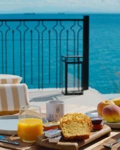 a table with a plate of food and a glass of orange juice at Sewelo Suites in Skinária