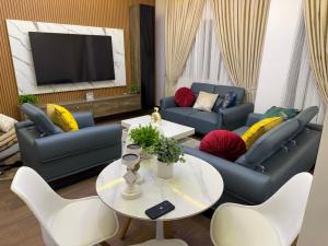 a living room with two couches and a tv at Luxury One bedroom Apartment R1 in Lomé +16 photos