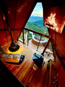 a room with a view of the mountains from a round room at Chalé Boutique Spa- Sauna seca, Jacuzzi , Rede suspensa in Campos do Jordão