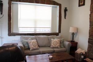 a living room with a couch and a window at Colorado Cottage W/Mountain View in Colorado Springs +48 photos