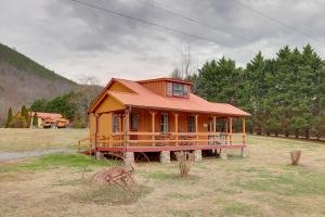a small house in the middle of a field at Blue Ridge Hideaway! Cabin w/ River Access & Views in Hot Springs