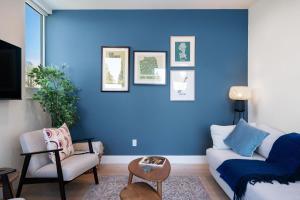 a blue living room with a couch and a chair at Wallingford Getaway in Seattle