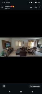 een foto van een woonkamer met een bed en een bank bij Casa Denis in Pântano Grande