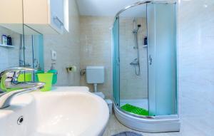 a bathroom with a shower with a sink and a toilet at Apartments Dalis in Milna +36 photos