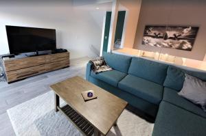 a living room with a blue couch and a table at Park City Ski in Ski Out in Old Town Walk To Main St in Park City