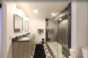 a bathroom with a shower and a sink and a mirror at Park City Ski in Ski Out in Old Town Walk To Main St in Park City +17 photos