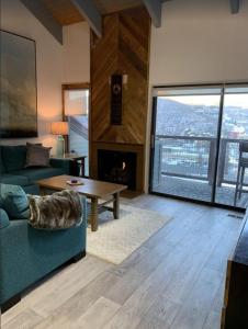 a living room with a couch and a fireplace at Park City Ski in Ski Out in Old Town Walk To Main St in Park City
