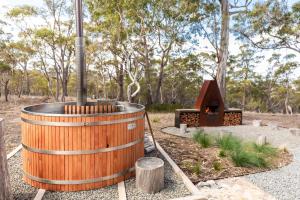 a wooden barrel with a fireplace in a park at Arden Retreat - The Croft at Richmond in Richmond